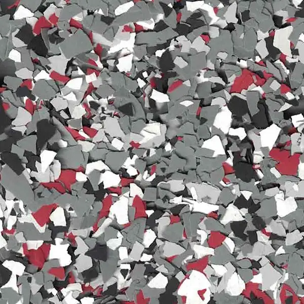 Multicolored epoxy floor with red, grey, black, and white flakes. The textured surface creates a modern, durable, speckled appearance for industrial or garage settings.