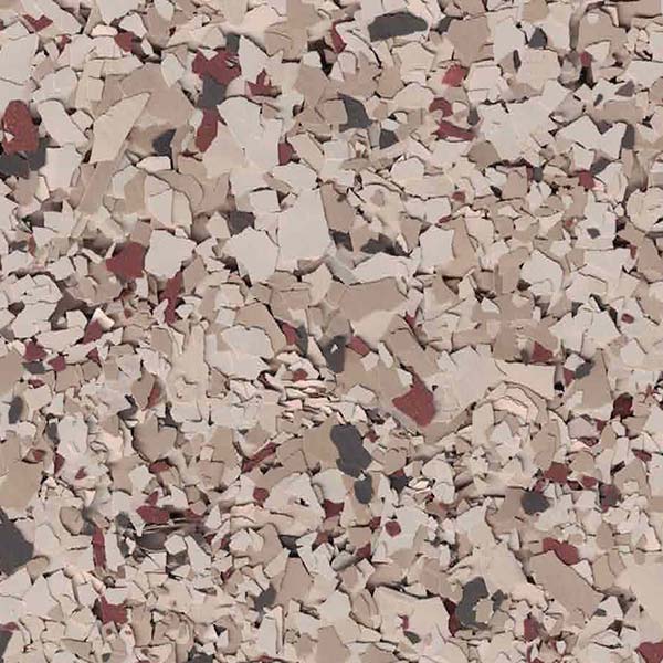 A close-up view of a textured surface with scattered pieces of beige, white, and red flakes forming an abstract pattern.