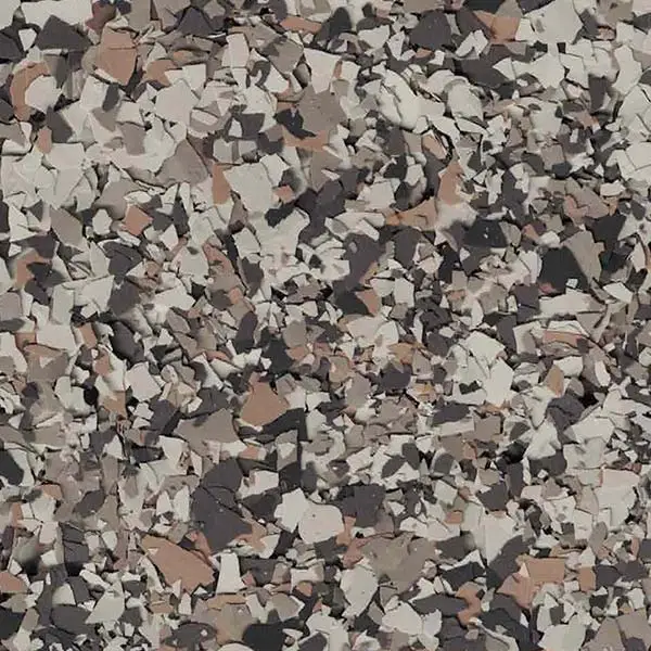 A close-up view of a textured concrete surface with a mix of beige, gray, and black irregular chips forming an abstract pattern.