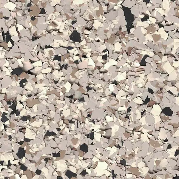 The image displays a close-up view of a textured, multicolored surface with scattered, irregular flakes in shades of beige, brown, and black.