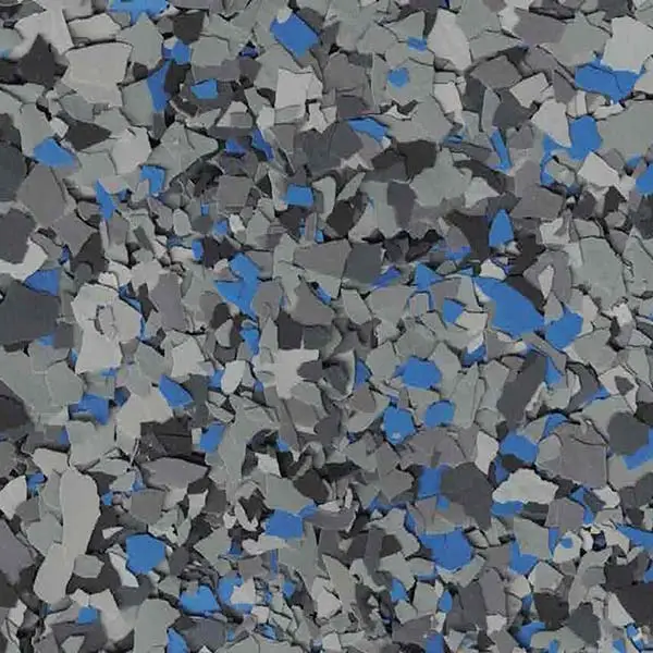 The image depicts a textured surface with a random pattern of grey, black, and blue flakes, resembling a floor or wall coating.