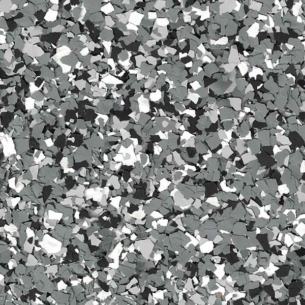 Close-up of a speckled gray, black, and white texture resembling terrazzo or stone chips, creating an abstract and intricate pattern.